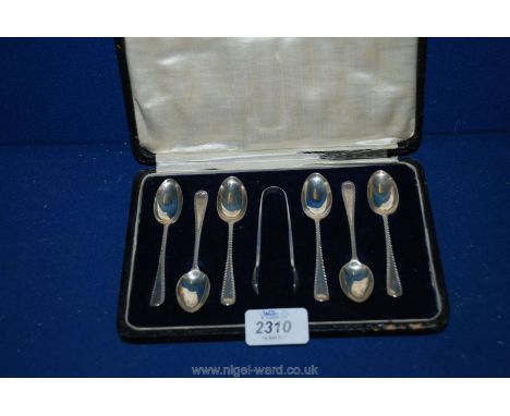 Six Silver Teaspoons and sugar Tongs, London 1919 feather edged 