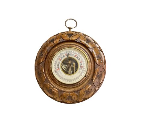 Early 20th century Aneroid barometer in a carved circular case and a German 8-day wall clock.