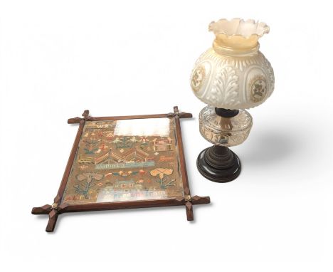 Needlework tapestry in oak Oxford frame, and an oil lamp with floral shade