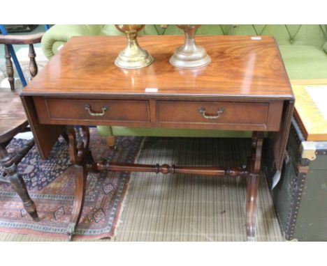 A GOOD QUALITY REPRODUCTION SOFA TABLE finished in mahogany, supported on lyre shaped uprights, united by a turned stretcher 