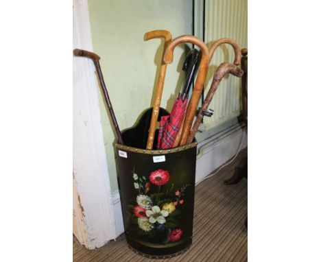 A PAINTED CORNER STICK STAND, containing a selection of sticks and a tartan brolly 