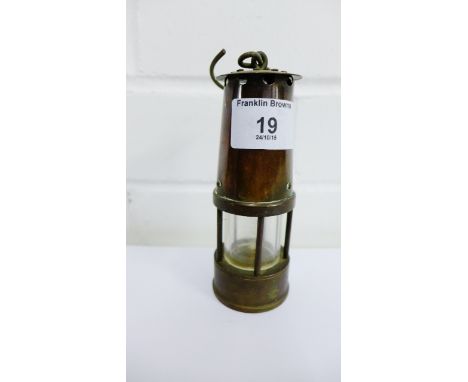 A miniature brass cased Miner's lamp, 12cm high 