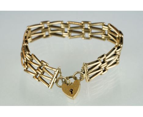 A fully hallmarked ladies 9ct gold gate bracelet with padlock safety chain. 