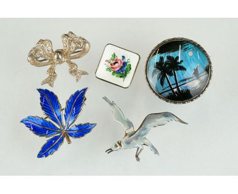 A collection of five sterling silver brooches to include two Norwegian enamel examples. 