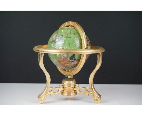 Table top globe made from semi precious stone with compass set to base, raised on three gilt metal legs. approx 20cm high 