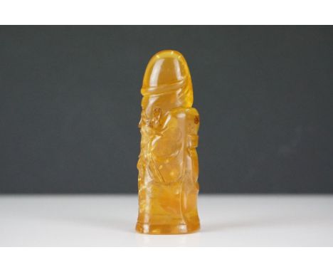 A carved amber Japanese Netsuke pendant in the form of a phallus 