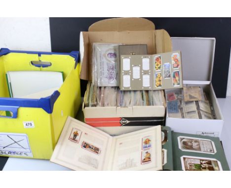 A large box of mixed ephemera to include tea cards, cigarette cards, ration books, vintage train tickets and postcards within