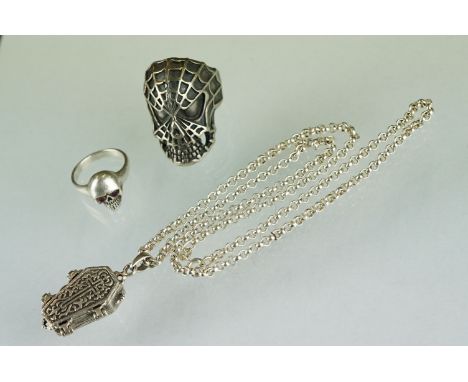 A small collection of contemporary silver jewellery to include a coffin necklace, skull ring and Spiderman ring. 