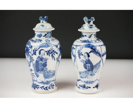 Near Pair of Chinese Blue and White Baluster Lidded Vases decorated with figures and birds, four character Kangxi marks to ba