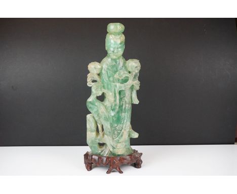 Chinese carved jade figure of Guanyin in robed dress, standing holding a flower, with a bird standing to their side, on a har