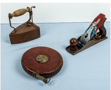A vintage plane, tape measure and a flat iron