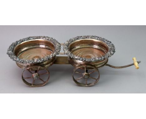 An Old Sheffield plate decanter wagon, first half 19th century, the pair of coasters with foliate borders on four spoked whee