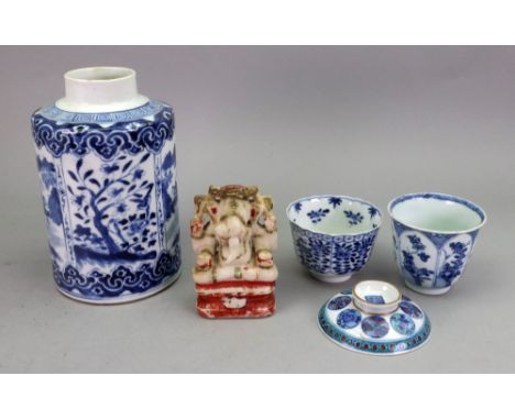 A Chinese blue and white cylindrical canister, late 19th century, painted with panels of a figure crossing a bridge alternati