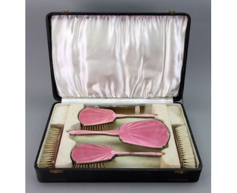 A cased six piece silver and pink guilloche enamel dressing table set, Birmingham 1932.