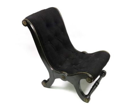 A late Regency ebonised gilt metal mounted slipper chair, button down upholstered in black.