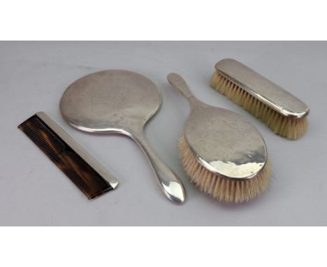 A three piece silver mounted dressing table set, Birmingham 1919, foliate engraved, very worn, and a similar mounted comb, Lo