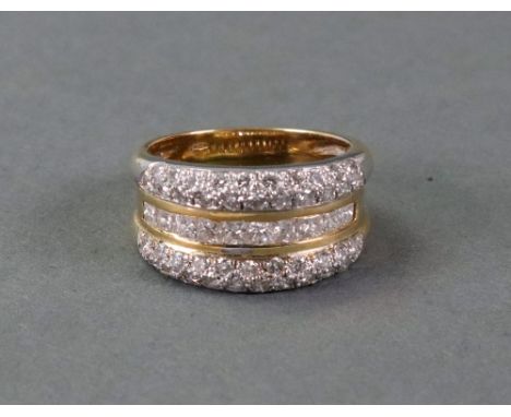 An 18ct gold and diamond three row ring, the ten princess cut diamonds channel set in gold, between two rows of white gold pa