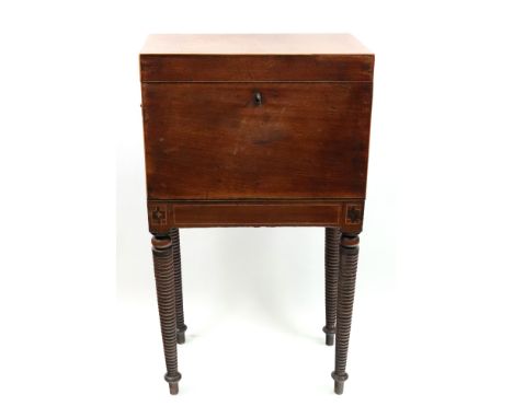 A George III mahogany boxwood and ebony banded rectangular teapoy and cellarette, the hinged cover enclosing a fitted interio