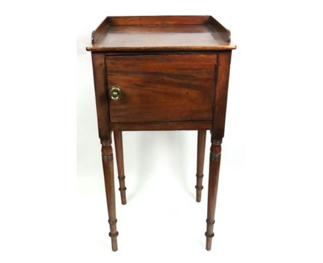 A Regency mahogany pot cupboard, with three quarter gallery, enclosed by a single door, on ring turned legs, 41cm wide x 37cm