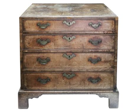 An early 18th century walnut and crossbanded chest, the moulded rectangular quarter veneered caddy top above four long gradua
