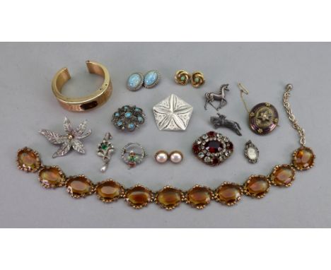 A collection of jewellery, comprising; a cultured pearl and blue enamel oval brooch in star, scrolling and geometric design, 