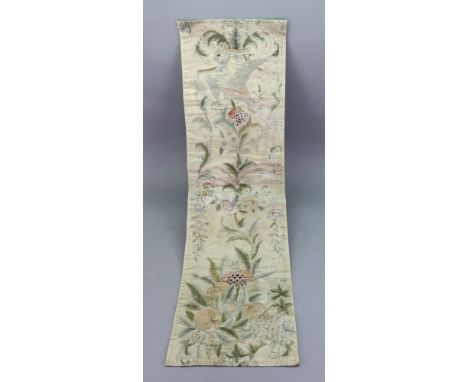 A rectangular silk panel, first half 19th century, embroidered with a bird perched on a flowering branch, with fruits at the 