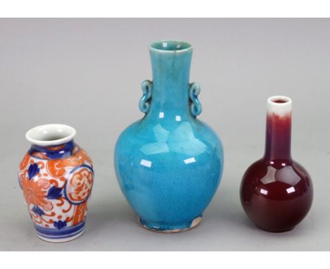 A miniature Chinese flambé bottle vase, 20th century, covered in a deep red glaze, indistinct blue seal mark, 10cm high, a Ch