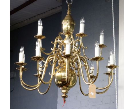 A Dutch style brass fifteen light chandelier, with scrolled branches, arranged in two rows, 84cm high.