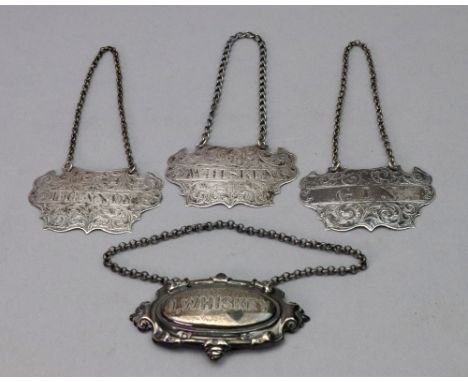 A set of three Victorian silver bottle tickets, Brandy, Gin and Whiskey, John Tongue, Birmingham 1857, cartouche shape, leafy