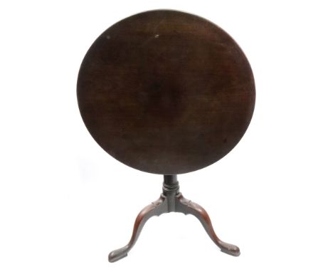 A George III mahogany tea table, the circular tilt top on a gun barrel turned pillar and tripod base with pad feet, 70 cm dia