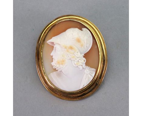 A gold mounted oval shell cameo brooch, carved as the portrait of a gentleman in a toga, within a rope twist border, dimensio