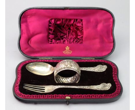 A child's cased Victorian silver spoon, fork and napkin ring, Martin Hall & Co, Sheffield 1890 and 1891, cast in rococo style