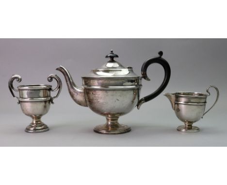 A George III style circular silver teapot and matching milk jug, Emile Viner, Sheffield 1932, with blackwood scroll handle an