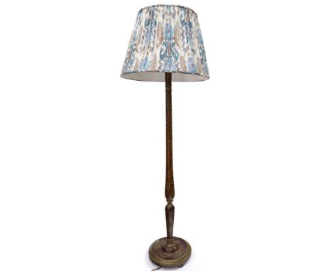 A chinoiserie lacquered and gilded standard lamp, circa 1920's, with a faux tortoiseshell ground, twin light, on a turned pil