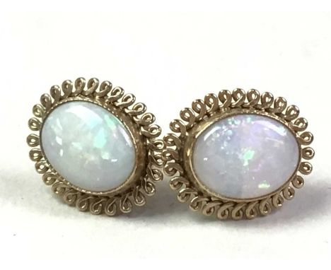 PAIR OF NINE CARAT GOLD AND OPAL EARRINGS , along with another pair of nine carat gold and opal earrings