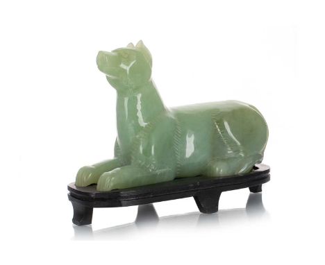 CHINESE JADE FIGURE OF A RECUMBENT DOG, 19TH/20TH CENTURY with brown inclusions, on hardwood stand19cm long