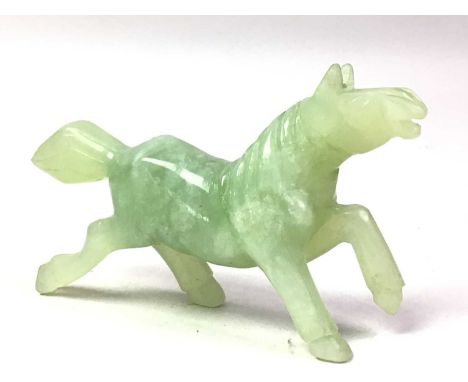 CHINESE JADE ANIMAL FIGURE, modelled as a horse, with white inclusions11cm long