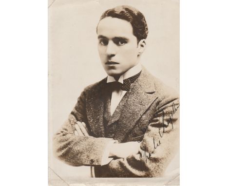 Charles Chaplin signed 7 x 5 sepia portrait photo of a young Chaplin with bow tie and tense look. Has corner crease marks whe