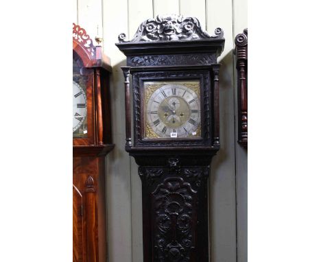 Antique carved oak eight day longcase clock, having square brass dial with silvered chapter ring, seconds and date signed Tho