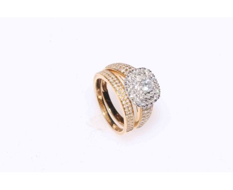 Diamond cluster ring set in 18 carat gold, having centre elevated 0.2 carat stone bordered with two continuous rows of 32 dia