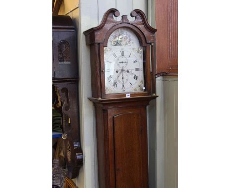 19th Century oak eight day longcase clock, the painted arch dial with fluted columns and scroll pediment, with pendulum, over