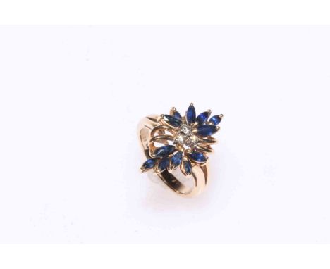 Sapphire and diamond flower design ring set in 14kt gold, size J.