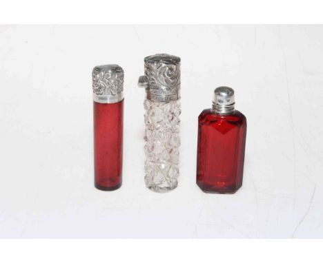 Three small silver mounted scent bottles including late Victorian ruby scent, Birmingham 1897 and cleat cut glass scent, Birm