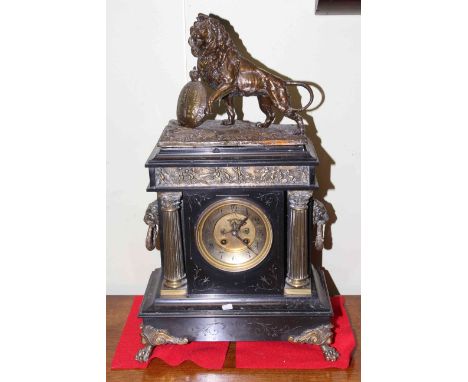 Large 19th Century gilt metal mounted black marble mantel clock, the circular dial flanked by columns, lion mask side handles