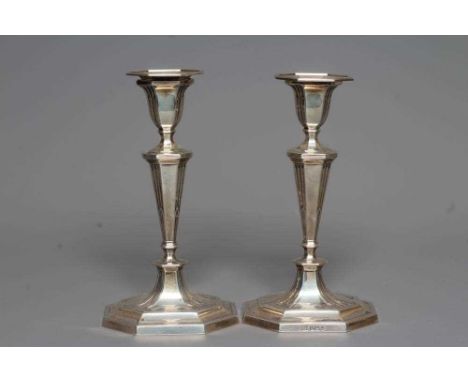 A COMPOSITE PAIR OF GEORGE V SILVER CANDLESTICKS by Harrison Bros. &amp; Howson, Sheffield 1910 &amp; 1912, the detachable oc