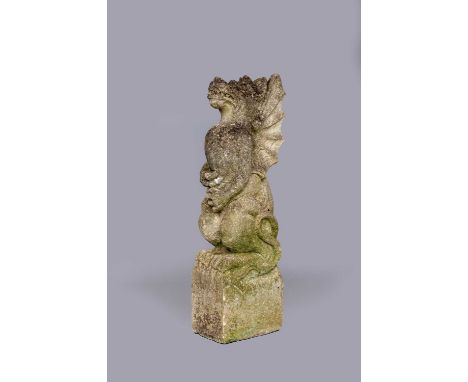 A CARVED SANDSTONE GARGOYLE CORBEL modelled as a seated winged beast holding a detachable flagpole, raised on square plinth, 