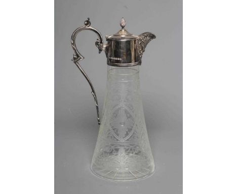 AN ELIZABETH II SILVER MOUNTED GLASS CLARET JUG of swept cylindrical form, cut and etched in the Edwardian style with bands o