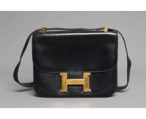 AN HERMES NAVY BLUE LEATHER CONSTANCE HANDBAG, 1972, with gold plated 'H' clasp, with single zippered (Eclair) pocket and one