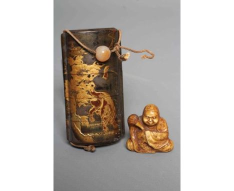 A JAPANESE LACQUER FOUR CASE INRO with two Temple Dogs in landscape on a dark green ground, polished hardstone ojime on a sil