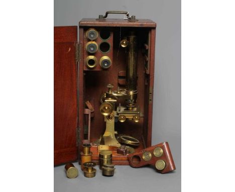 A LATE VICTORIAN BINOCULAR MICROSCOPE BY DOLLAND, LONDON with assorted optics, lenses and accessories contained in a fitted m